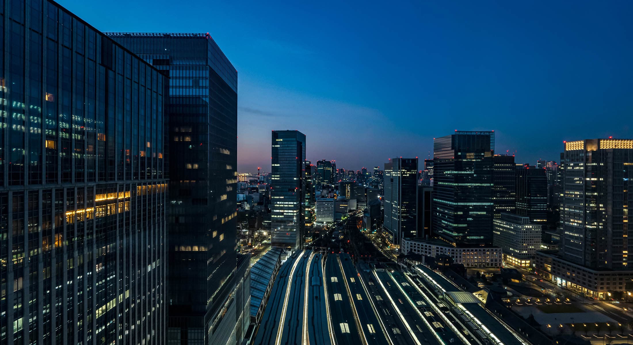 Tokyo Station at dusk, warm lights against a deep blue sky